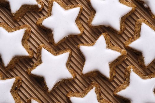 glazed nut star shaped cookies on paper background