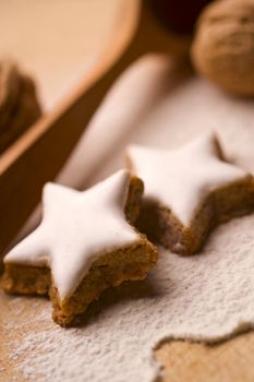 glazed star shaped cookies on wooden board, close up
