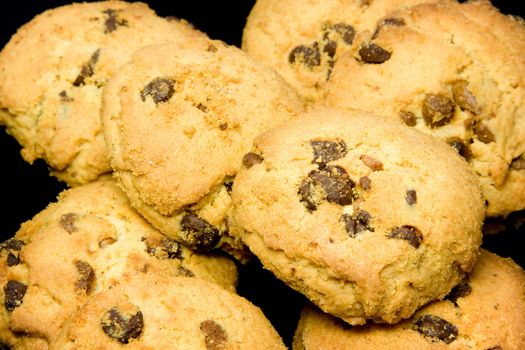 Chocolate cookies over dark reflective surface