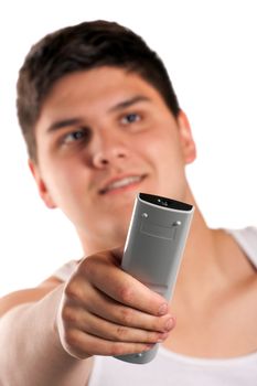 A teenager changes the channel with the remote control isolated over a white background. Shallow depth of field.