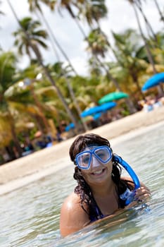 A Hispanic woman snorkeling in the tropical waters of the Caribbean sea.
