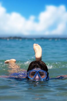 A Hispanic woman snorkeling in the tropical waters of the Caribbean sea.