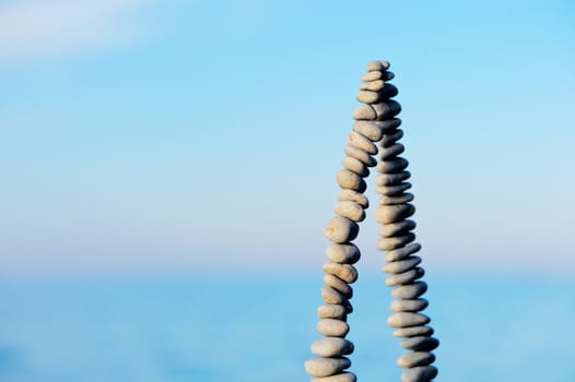 Pile of pebbles as pyramid against the background of sky