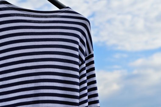 Blue striped vest against the blue sky