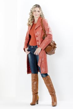 woman wearing fashionable brown boots with a handbag