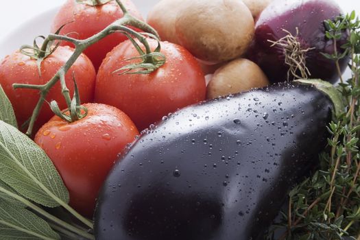 Eggplant, onion, tomatoes and fresh herbs for Italian cooking.  