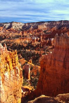 Bryce Canyon National Park is a national park located in southwestern Utah in the United States. Contained within the park is Bryce Canyon. Despite its name, this is not actually a canyon, but rather a giant natural amphitheater created by erosion along the eastern side of the Paunsaugunt Plateau. Bryce is distinctive due to its geological structures, called hoodoos, formed from wind, water, and ice erosion of the river and lakebed sedimentary rocks. The red, orange and white colors of the rocks provide spectacular views to visitors.