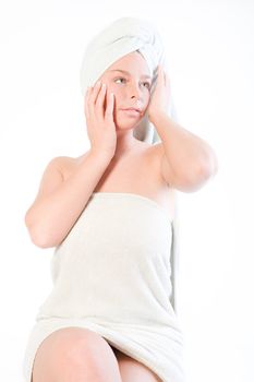 Studio portrait of a spa girl touching the towel on her head