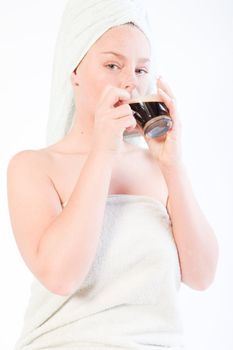 Studio portrait of a spa girl drinking coffee out of a glass