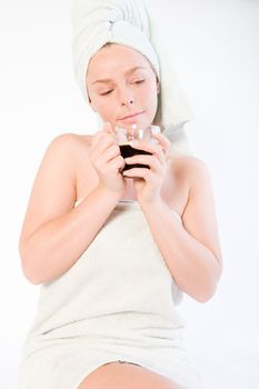 Studio portrait of a spa girl dreaming while drinking coffee