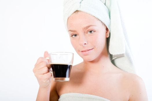 Studio portrait of a spa girl drinking coffee and making eye contact