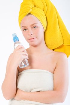 Studio portrait of a spa girl with a water bottle