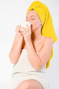 Studio portrait of a spa girl enjoying coffee