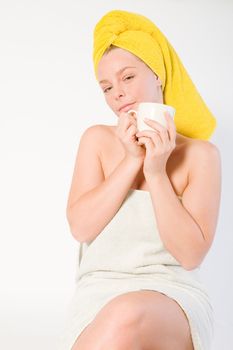 Studio portrait of a spa girl drinking coffee