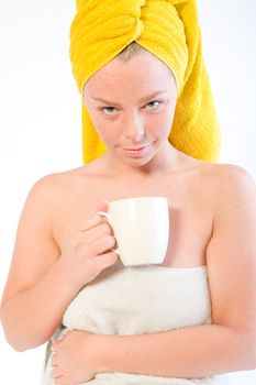 Studio portrait of a spa girl drinking coffee and watching