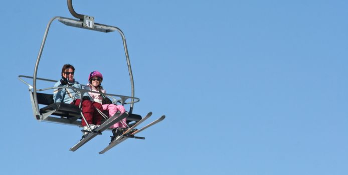 Two women riding on the Ski lift on Holiday