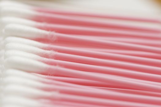 line of cotton buds with pink plastic basis