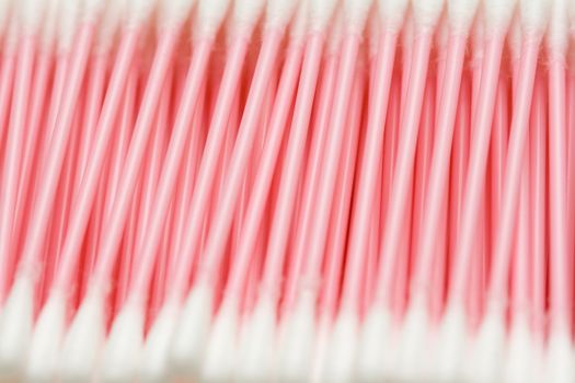 line of cotton buds with pink plastic basis