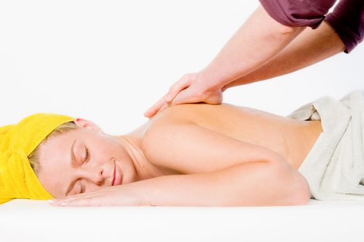 Studio portrait of a spa girl getting a shoulder massage