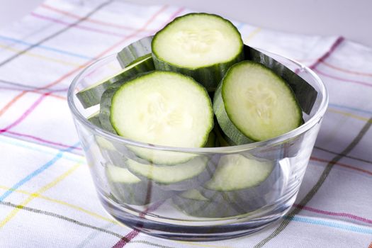 Cucumber slices in clear glass bowl.