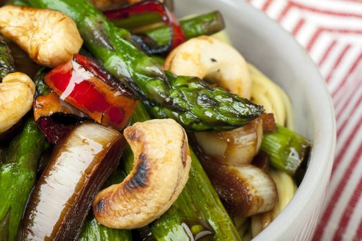 Asparagus, hot peppers, onions and cashews stir fried and served over Chinese noodles.