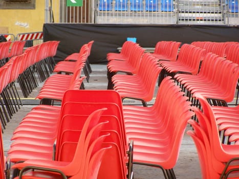 rows of red chairs in an audience