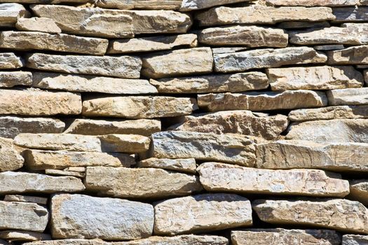 A stone wall showing patterns, detail, and texture