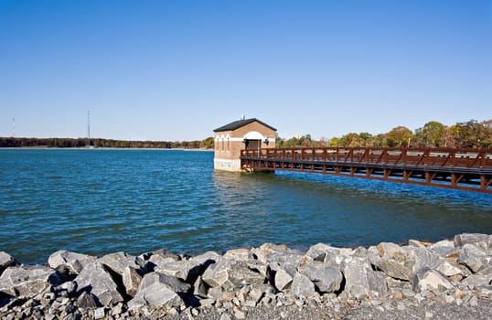 A reservoir with a pier and a building over the water