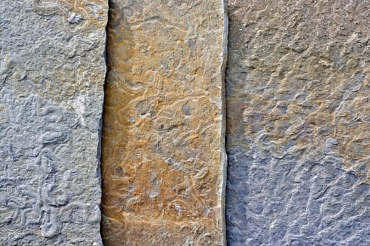 Closeup of a slate wall showing much detail and texture