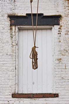Doorway of an old building with rope hanging in front of it