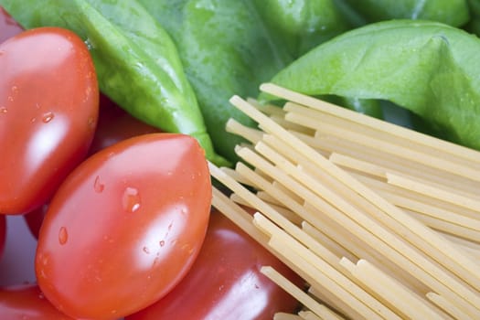 Tomatoes, spaghetti and basil: ingredients for a pasta dinner.  