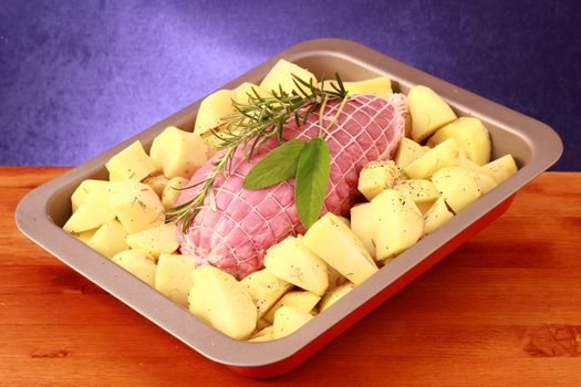 Roast herb-coated lamb with roasted potatoes 