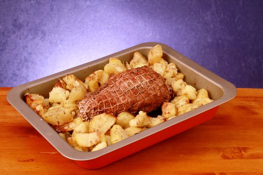 Roast herb-coated lamb with roasted potatoes 