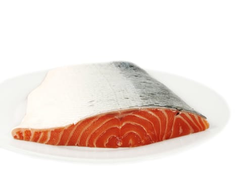 Fresh raw salmon, on white plate, with skin, isolated towards white