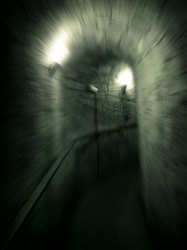 Moving trough long dark  corridor . Zoom motion effect photo.