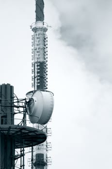 Communications tower with antennas , black and white toned photo