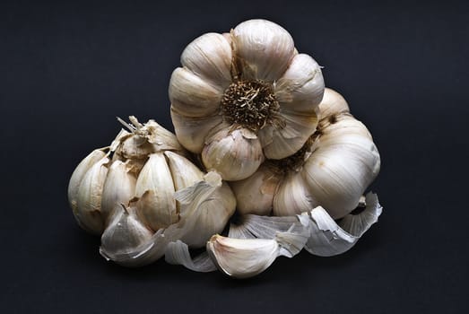 Some garlic isolated on a black background.