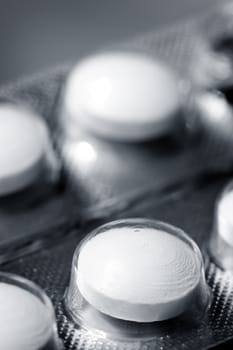 Macro of pills, black and white toned photo with shallow DOF