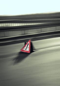 Danger sign on the road with motion effect
