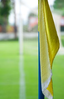 Detail of a football (soccer) field with a yellow corner flag