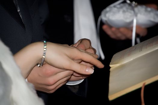 Exchanging rings at a wedding ceremony in the church. Shallow DOF photo