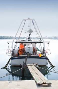 Fishing boat at the docks on a calm sunny day