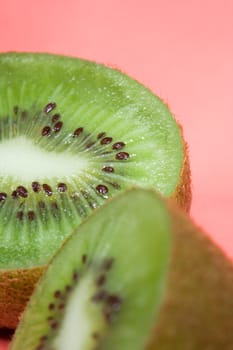 Kiwi on red background , close up photo