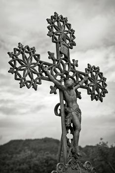 Old cross against the sky , black and white toned photo