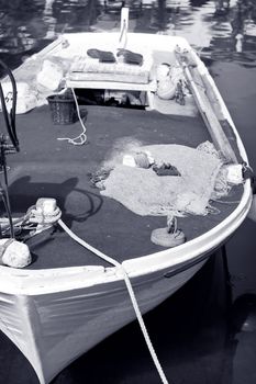 Old small wooden fishing boat - black and white toned photo
