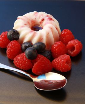 creme caramel with raspberry an blueberry 