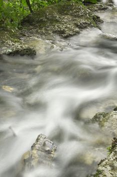 Beautiful small waterfall in springtime , long exposure photo for water motion effect