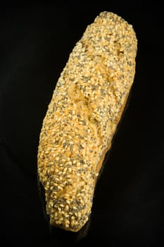 Loaf of bread on black background with space for your text.