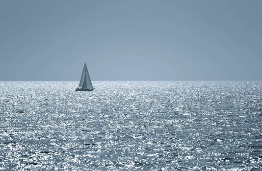 A small boat sailing on a sunny morning , toned photo
