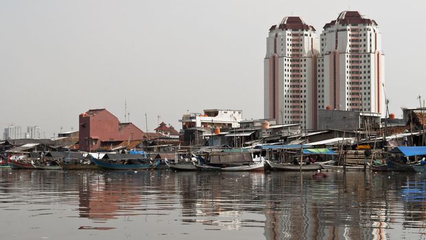 Old canal full of boats in Jakarta harbor, Indonesia